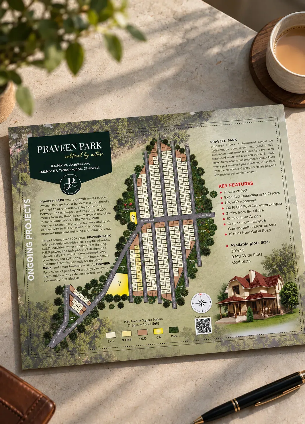 Praveen Park plot layout brochure, Dharwad, laid out on a table